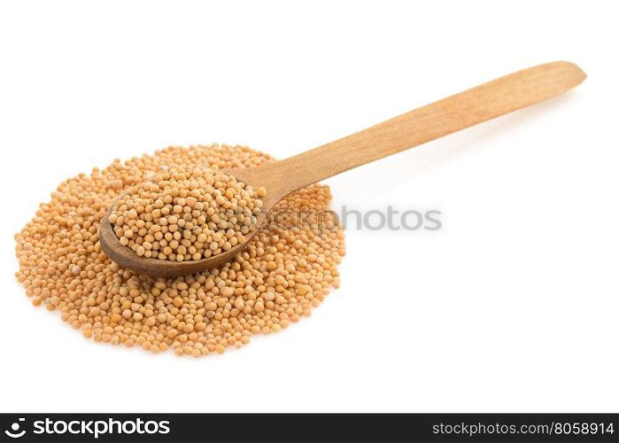 mustard spices in spoon isolated on white background