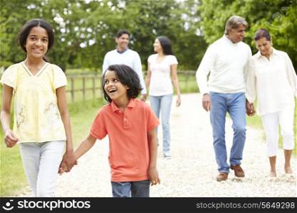 Muti-Generation Indian Family Walking In Countryside