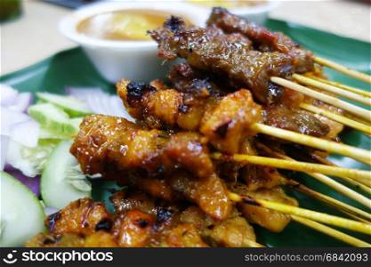 Mutton and chicken satay with chopped cucumbers and onions