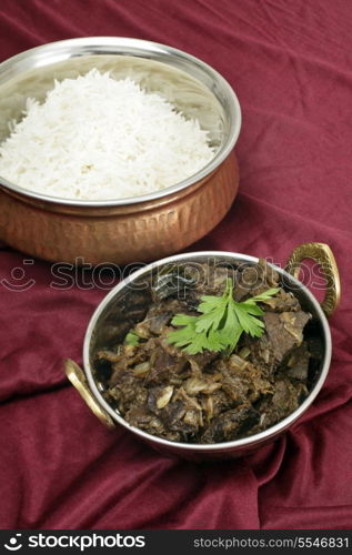 Mutton liver fried with onion and indian spices to make a traditional Kerala (South India) fry, served with basmati long-grain rice