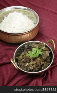 Mutton liver fried with onion and indian spices to make a traditional Kerala (South India) fry, served with basmati long-grain rice