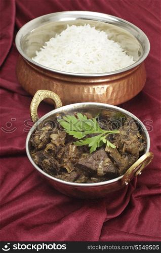 Mutton liver fried with onion and indian spices to make a traditional Kerala (South India) fry, served with basmati long-grain rice