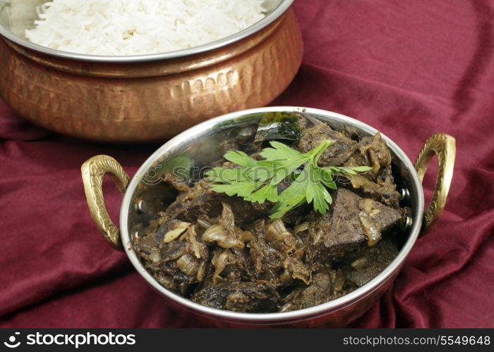 Mutton liver fried with onion and indian spices to make a traditional Kerala (South India) fry, served with basmati long-grain rice