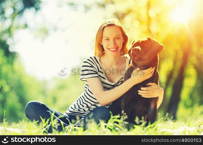 My best friend. Young girl with retriever on walk in summer park