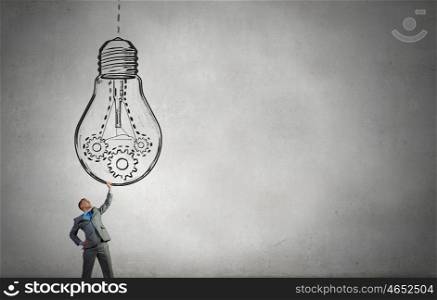 My big idea. Young businessman holding in hands big light bulb