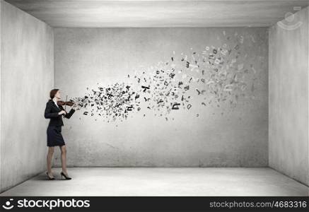 My business melody. Young businesswoman in cement room playing violin