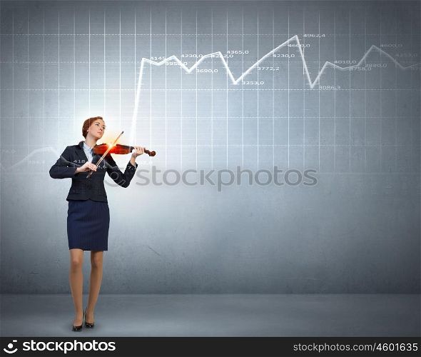My business melody. Young businesswoman playing violin and financial graphs at background