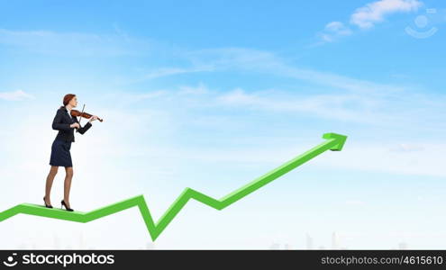 My business melody. Young businesswoman playing violin standing on growing graph