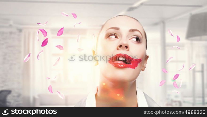 My favourite red pomade. Attractive woman applying red lipstick with brush