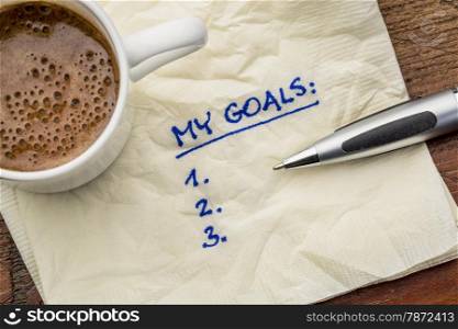 my goals list on a napkin with cup of coffee