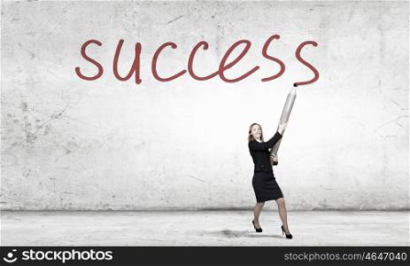 My great idea. Businesswoman drawing word success with huge pencil