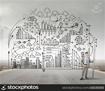 My great plan. Businessman drawing plan strategy success with huge pencil