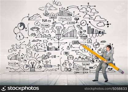 My great plan. Businessman drawing plan strategy success with huge pencil