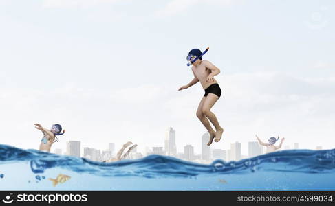 My great summer vacation. Kid boy in diving mask making jump in to water