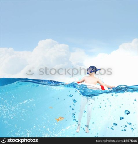 My great summer vacation. Kid boy of school age in diving mask swimming in life buoy