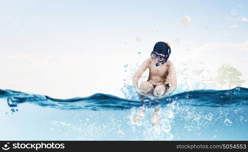 My great summer vacation. Kid boy of school age in diving mask jumping in water