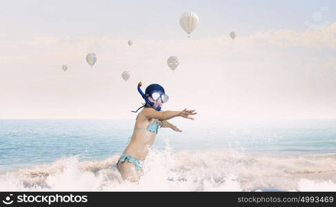 My great summer vacation. Kid girl in diving mask jumping in water