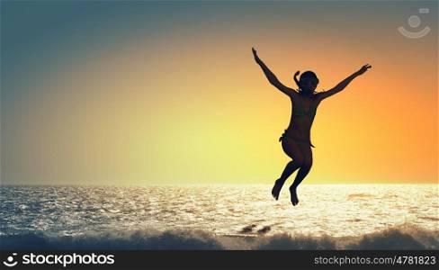 My great summer vacation. Kid girl of school age in diving mask on sunset background
