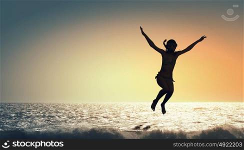 My great summer vacation. Kid girl of school age in diving mask on sunset background