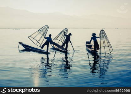 Myanmar travel attraction landmark - Traditional Burmese fisherman at Inle lake, Myanmar famous for their distinctive one legged rowing style