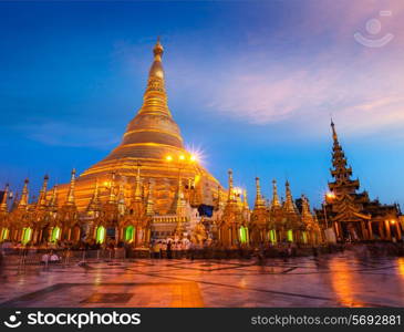 Myanmer famous sacred place and tourist attraction landmark - Shwedagon Paya pagoda illuminated in the evening. Yangon, Myanmar Burma