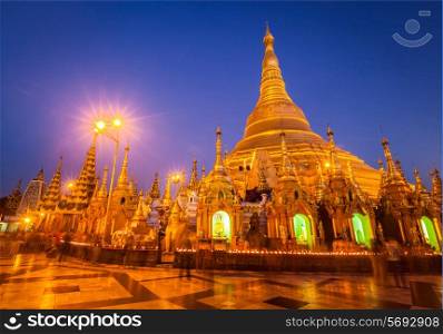 Myanmer famous sacred place and tourist attraction landmark - Shwedagon Paya pagoda illuminated in the evening. Yangon, Myanmar Burma
