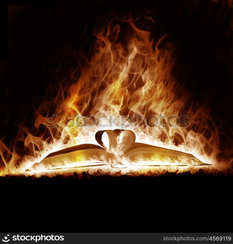 Mysterious Book open arms fire on a black background