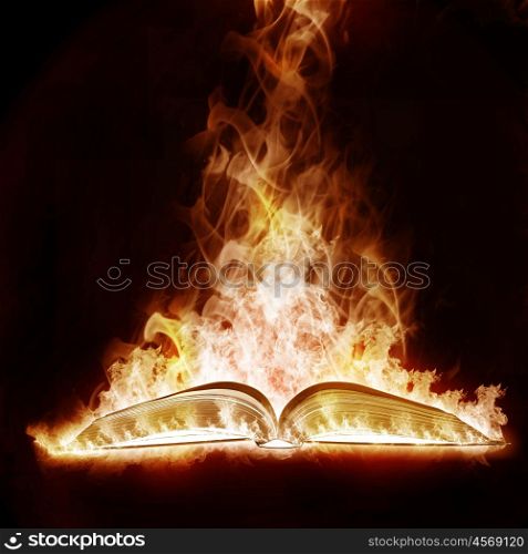 Mysterious Book open arms fire on a black background