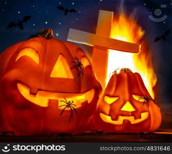 Mysterious Halloween night, glowing pumpkins with spiders on it, cross near burning flame, flying bat in dark starry night, fear concept