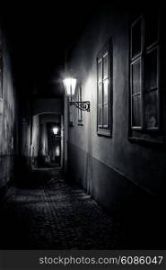 mysterious narrow alley with lanterns in Prague at night