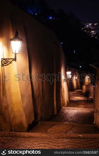 mysterious narrow staircase alley with lanterns in Prague at night