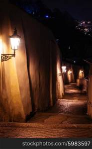 mysterious narrow staircase alley with lanterns in Prague at night