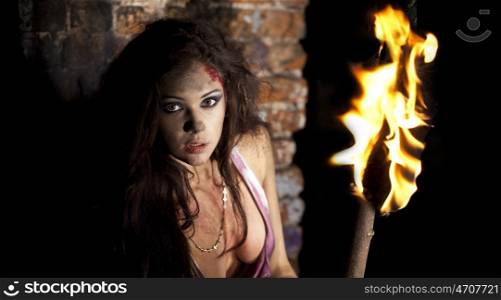 Mysterious sexy woman with torch in hand