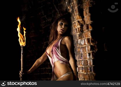 Mysterious sexy woman with torch in hand