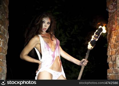 Mysterious sexy woman with torch in hand