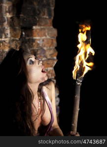 Mysterious sexy woman with torch in hand