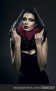 mysterious woman in black hood in dark
