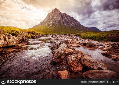 Mystic river mountain landscape scenery in Scotland. Glen Coe, Scottish Highlands. Sunshine.