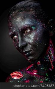Mystical woman makeup with sparkles and luminous elements on a dark background. Mystical makeup of a woman in the dark