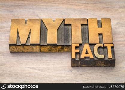myth and fact word abstract in letterpress wood type printing blocks against grained wood