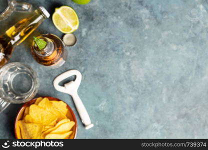 Nachos and beer on blue background, flat lay, copy space