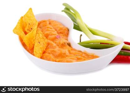Nachos, cheese sauce, vegetables isolated on white background.