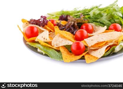 Nachos, cherry tomatos, lettuce, herbs in plate on white background.