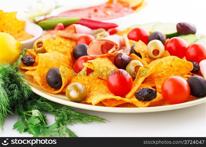 Nachos, olives, pork loin and vegetables image.