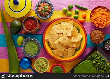Nachos tortilla chips with mexican sauces on colorful table