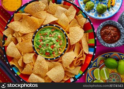 Nachos with guacamole tortilla chips in sombrero plate and sauces