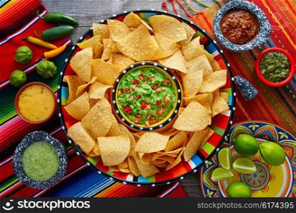 Nachos with guacamole tortilla chips in sombrero plate and sauces