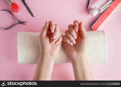 Nail care procedure in a beauty salon. Female hands and tools for manicure on a pink background. Concept spa bodycare.. Nail care procedure in a beauty salon. Female hands and tools for manicure on pink background. Concept spa bodycare.