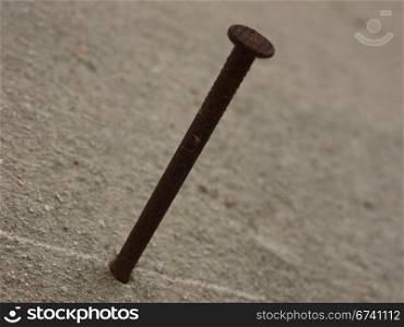 nail in a wall. rusty nail in a wall