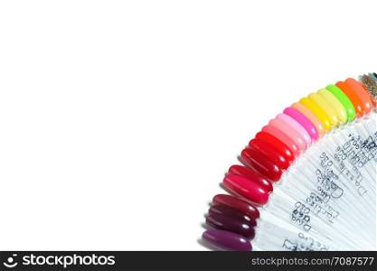 Nail polish palette in different colors isolated on white background. Copy space for text, top view, flat lay.